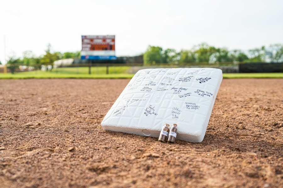 photo of a baseball base with signatures on it photo of a baseball base with signatures on it