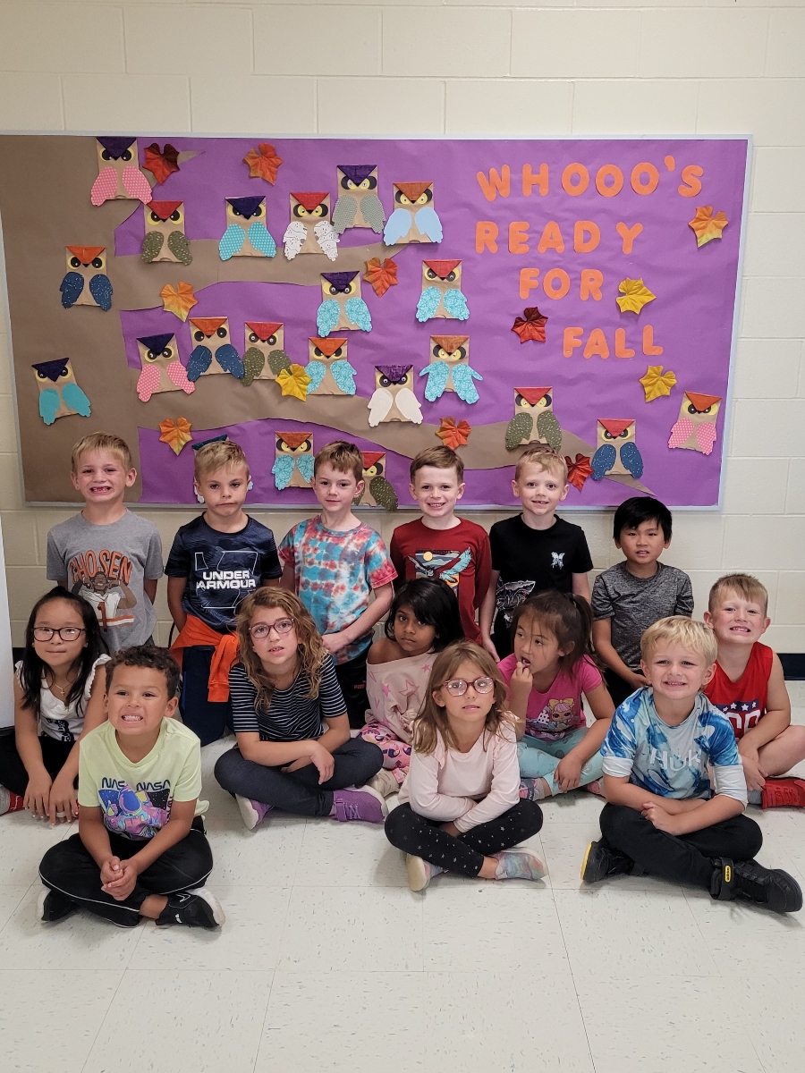 Kids with their art hanging on the wall