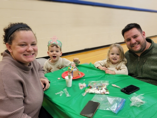 parents sitting at a table at gingerbread night